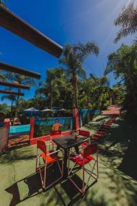 a table and chairs sitting next to a pool at Cabañas Riberas del Paraná in Puerto Iguazú