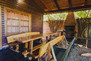 a wooden table in a room with a fireplace at Cabañas Riberas del Paraná in Puerto Iguazú