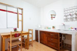 a kitchen with a sink and a table and a dining room at Magic Cusco in Cusco