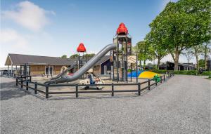 a playground with a slide at a park at Stunning Home In Assens With Kitchen in Assens