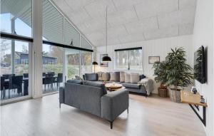 a living room with a couch and a table at Stunning Home In Væggerløse With Sauna in Marielyst