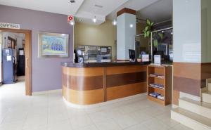 a lobby of a hospital with a checkout counter at Hotel Olympia Ronda I in El Puig