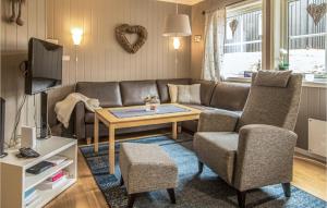 a living room with a couch and a table and chairs at Nice Apartment In Trysil With House A Panoramic View in Trysil