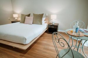 a bedroom with a bed and a table at The Lodge Jamberoo in Jamberoo