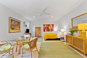 a bedroom with a bed and a table and chairs at Top of the town in Bangalow