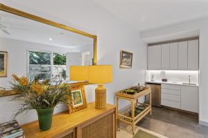 a kitchen with a table with a lamp and a mirror at Top of the town in Bangalow