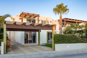 a villa with a palm tree and a building at Cabo Villa - G3 Punta Arena - 3 Bed 2.5 Bath in Cabo San Lucas