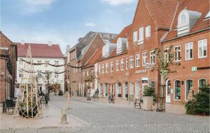 an empty street in a city with brick buildings at 4 Bedroom Stunning Home In Tnder in Tønder