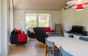 a living room with a table and chairs at Stunning Home In Allinge in Allinge