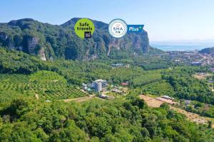 two hot air balloons flying over a mountain at Anana Ecological Resort Krabi-SHA Extra Plus in Ao Nang Beach