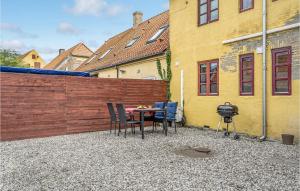 a patio with a table and chairs and a grill at Awesome Apartment In Bandholm With Kitchen in Bandholm