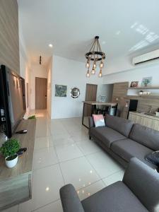 a living room with a couch and a kitchen at 2Bedroom Sutera Avenue Kota Kinabalu by Twen8ty Homestay in Kota Kinabalu