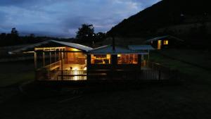 a house lit up at night with lights at ReverdeSer Glamping in Tabio