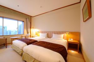 Postel nebo postele na pokoji v ubytování Hotel Okura Niigata