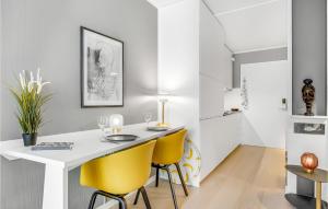 a dining room with a white table and yellow chairs at Stunning Home In Helsingr With Wifi in Helsingør