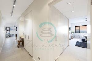 a white hallway with a sign on a wall at ZEN POINT PENTHOUSE 3-BR Executive W/front Retreat in Darwin