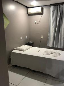 Voodi või voodid majutusasutuse Iapi Hotel toas