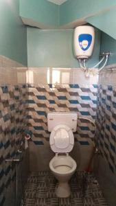 een badkamer met een wit toilet in een kamer bij Sunshraya Homestay in Darjeeling