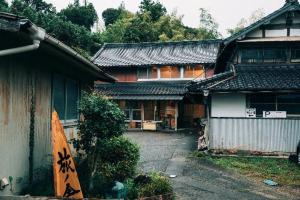 a house with a surfboard in front of it at Tabinoya / Vacation STAY 17823 in Kakegawa