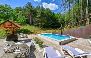 a backyard with a pool and chairs and a gazebo at Beautiful Home In Klenovnik With Sauna in Klenovnik