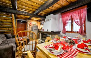 a dining room with a table and a fireplace at Beautiful Home In Klenovnik With Sauna in Klenovnik
