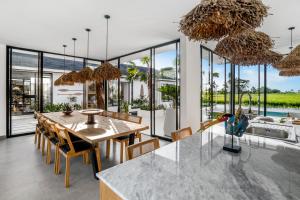 a kitchen and dining room with a table and chairs at Villa Nature View by BaliSuperHost in Ubud +18 photos