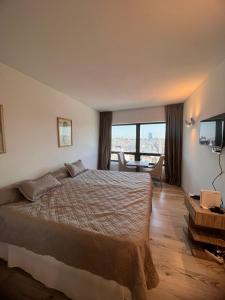 1 dormitorio con 1 cama grande y TV en BUENOS AIRES OASIS en Buenos Aires
