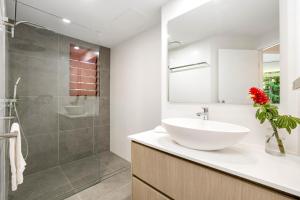 y baño con lavabo blanco y ducha. en Oasis at Palm Cove en Palm Cove