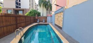 a swimming pool on the side of a building at Nirvana Boutique Suites in Jomtien Beach