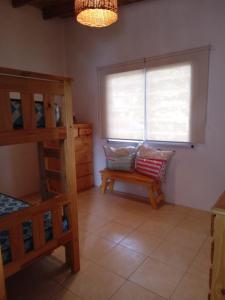 a bedroom with a bunk bed and a window at descanso in Mar Azul +2 photos