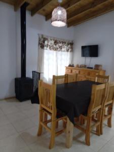 a dining room with a black table and chairs at descanso in Mar Azul