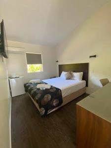 a bedroom with a large bed and a window at Coal n Cattle Hotel Motel in Moura