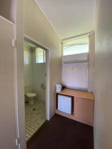 a small bathroom with a sink and a toilet at Coal n Cattle Hotel Motel in Moura
