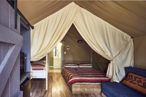 a room with a tent with beds in it at NRMA Port Arthur Holiday Park in Port Arthur