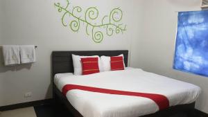 a bedroom with a large bed with red pillows at Regal Residences in Manila