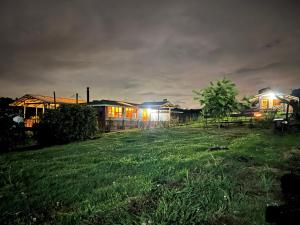 a group of houses in a field at night at ReverdeSer Glamping in Tabio