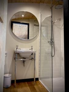 a bathroom with a sink and a shower at Hares Retreat - Middle Cabin in Foolow