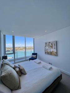 a bedroom with a large bed with a large window at Bayview 705 in Mandurah