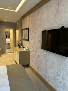 a hotel room with a large flat screen tv on a wall at City Park INN - Art Studio in Plovdiv