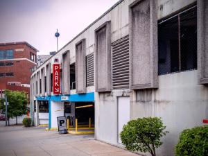 a building on a city street with a gas station at HostWise Stays - The Washington at Chatham - Free Parking, Private Gym, Skyline Views! in Pittsburgh