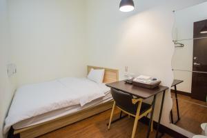 Ένα ή περισσότερα κρεβάτια σε δωμάτιο στο Douzi Hotel-Xpark. Gloria Outlets. Taoyuan MRT