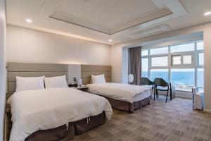 Postel nebo postele na pokoji v ubytování Cocoon Hotel