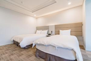 Postel nebo postele na pokoji v ubytování Cocoon Hotel