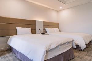 Postel nebo postele na pokoji v ubytování Cocoon Hotel