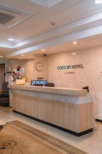 a lobby of a hotel with a reception counter at Cocoon Hotel in Jeju