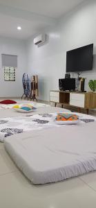 a large white room with a large bed on the floor at LOW SEASON PROMOTION! 4B12B max 25 pax Party House in Ipoh