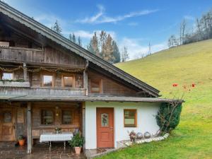 a wooden house with a bench in front of it at Charming holiday home in F genberg with lots of comfort in Fügenberg