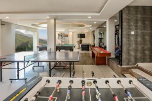 a ping pong room with ping pong tables and a pool table at Regenta Resort Exotica Dharamshala on Hilltop in Dharamshala