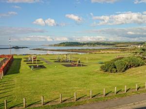 an empty park with a playground in a field at Meadowbank in Girvan