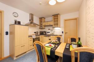 a kitchen with a table and chairs in a room at Urlaubsoase im Edertal in Bad Berleburg